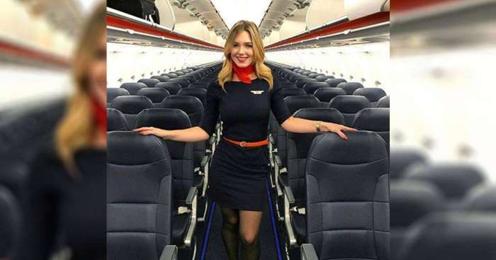 A flight attendant pulls her 70.0 n